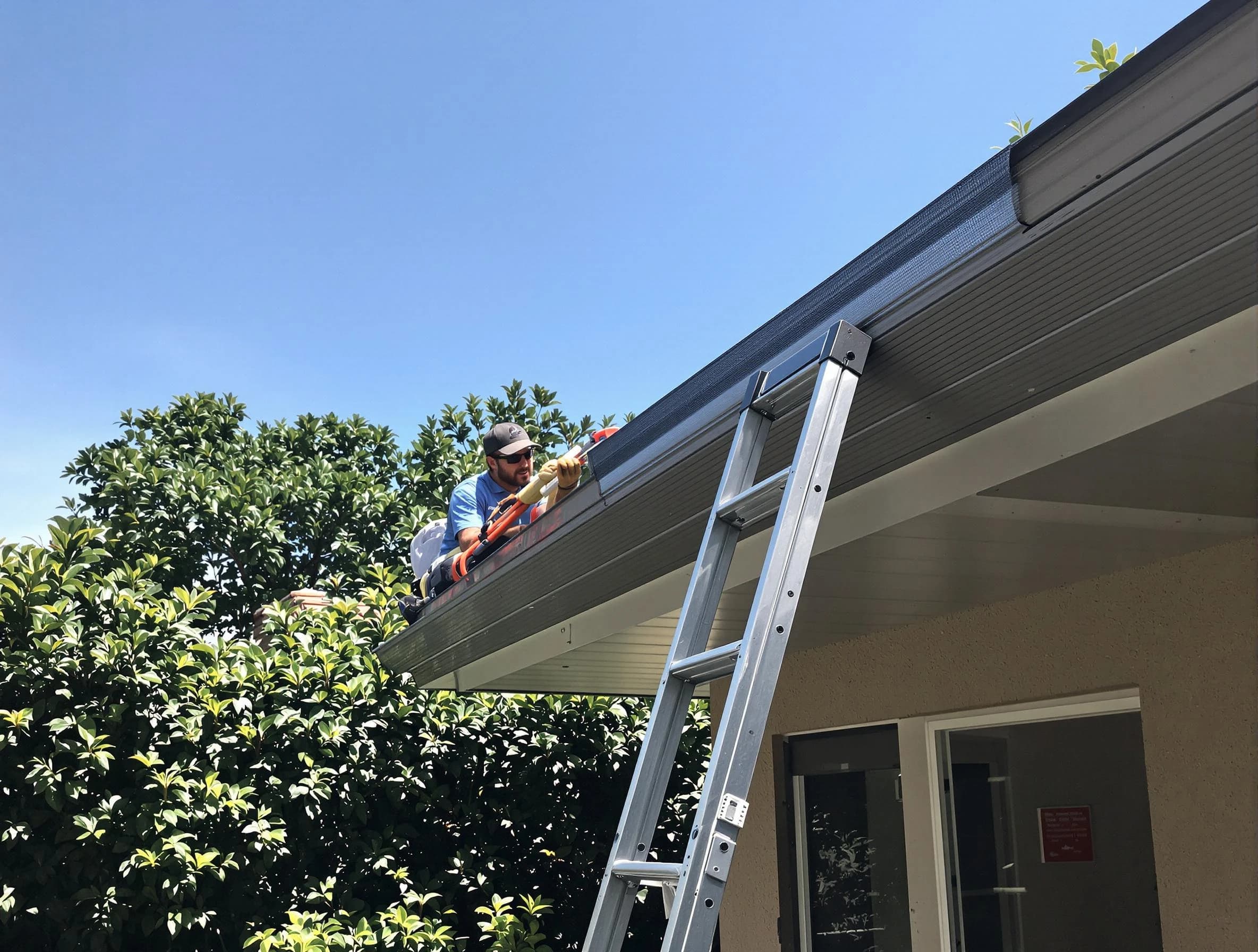 Westlake Roofing Company installing gutter guards for a homeowner in Westlake, OH